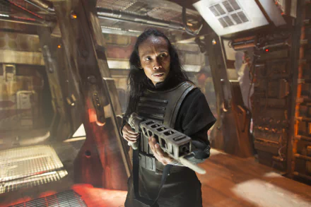 4K Ultra HD PC desktop wallpaper: long‑haired combatant grips a heavy blaster inside a gritty starship corridor, capturing the Star Wars movie mood of Star Wars Episode VII.