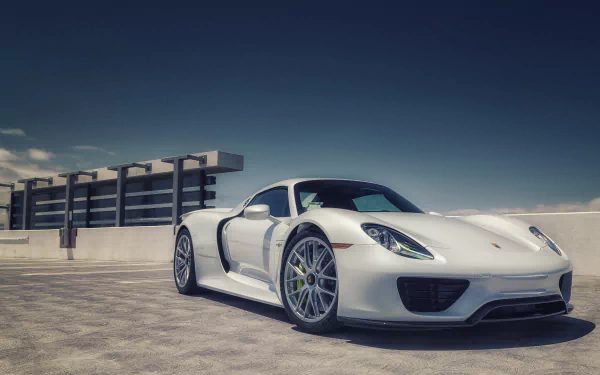 White Porsche 918 Spyder supercar parked on a sunlit rooftop under a deep blue sky — 4K Ultra HD PC desktop wallpaper/background.