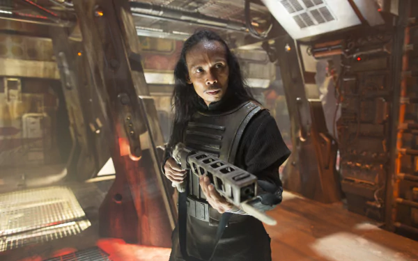 4K Ultra HD PC desktop wallpaper: long‑haired combatant grips a heavy blaster inside a gritty starship corridor, capturing the Star Wars movie mood of Star Wars Episode VII.