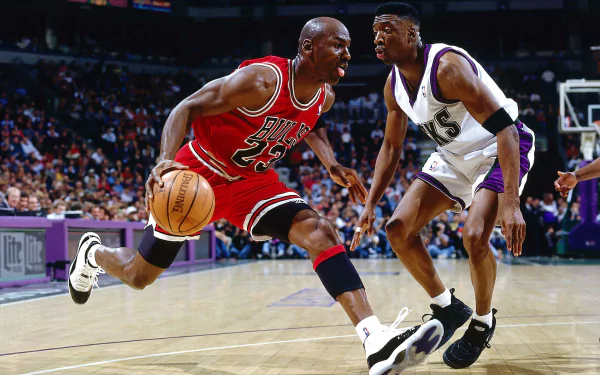 HD wallpaper featuring a basketball player in action wearing a red #23 jersey, dribbling past an opponent on the court.