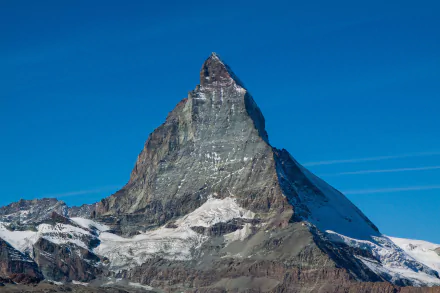 A stunning view of the Matterhorn peak in the Alps, showcasing its snow-capped summit against a clear blue sky, perfect for a nature-inspired HD desktop wallpaper.