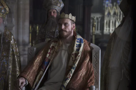 Michael Fassbender as Macbeth in a regal costume, seated on a throne in a dimly lit medieval setting, captured in 4K Ultra HD for a PC desktop wallpaper.