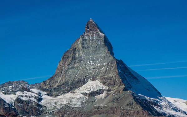 HD wallpaper of the Matterhorn peak in the Alps, showcasing a snowy mountain under a clear blue sky.