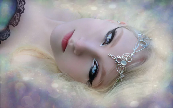 A dreamy fantasy scene featuring a blonde woman with blue eyes and a delicate bindi, exuding a mystical mood. A captivating HD wallpaper that enhances any desktop background.