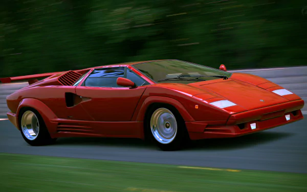 Red Lamborghini Countach vehicle in motion on a road — vibrant 4K Ultra HD PC desktop wallpaper background.