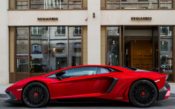 A striking red Lamborghini Aventador SV parked in front of a DSQUARED2 store, captured in vivid 4K Ultra HD quality.