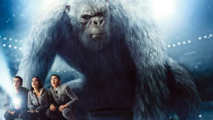 HD PC desktop wallpaper featuring a large, furry creature from the Goosebumps movie, with three characters looking up at it in a dramatic scene.