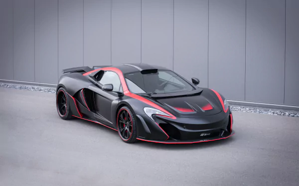 Black McLaren 650S supercar with red accents parked against a modern gray wall, featured as a 4K Ultra HD PC desktop wallpaper and background.