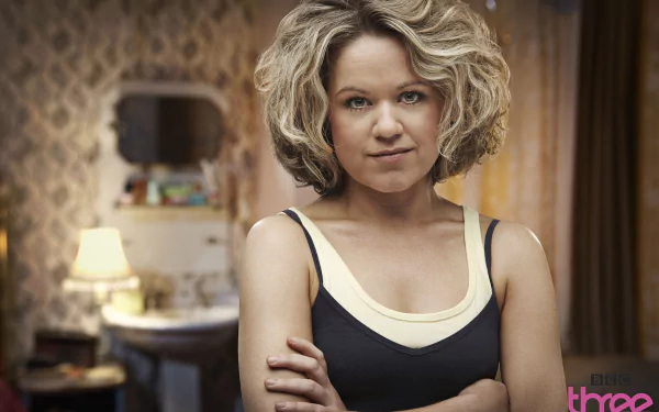 Nina Pickering from the TV show Being Human stands confidently in a warmly lit room, captured in an HD desktop wallpaper and background image.