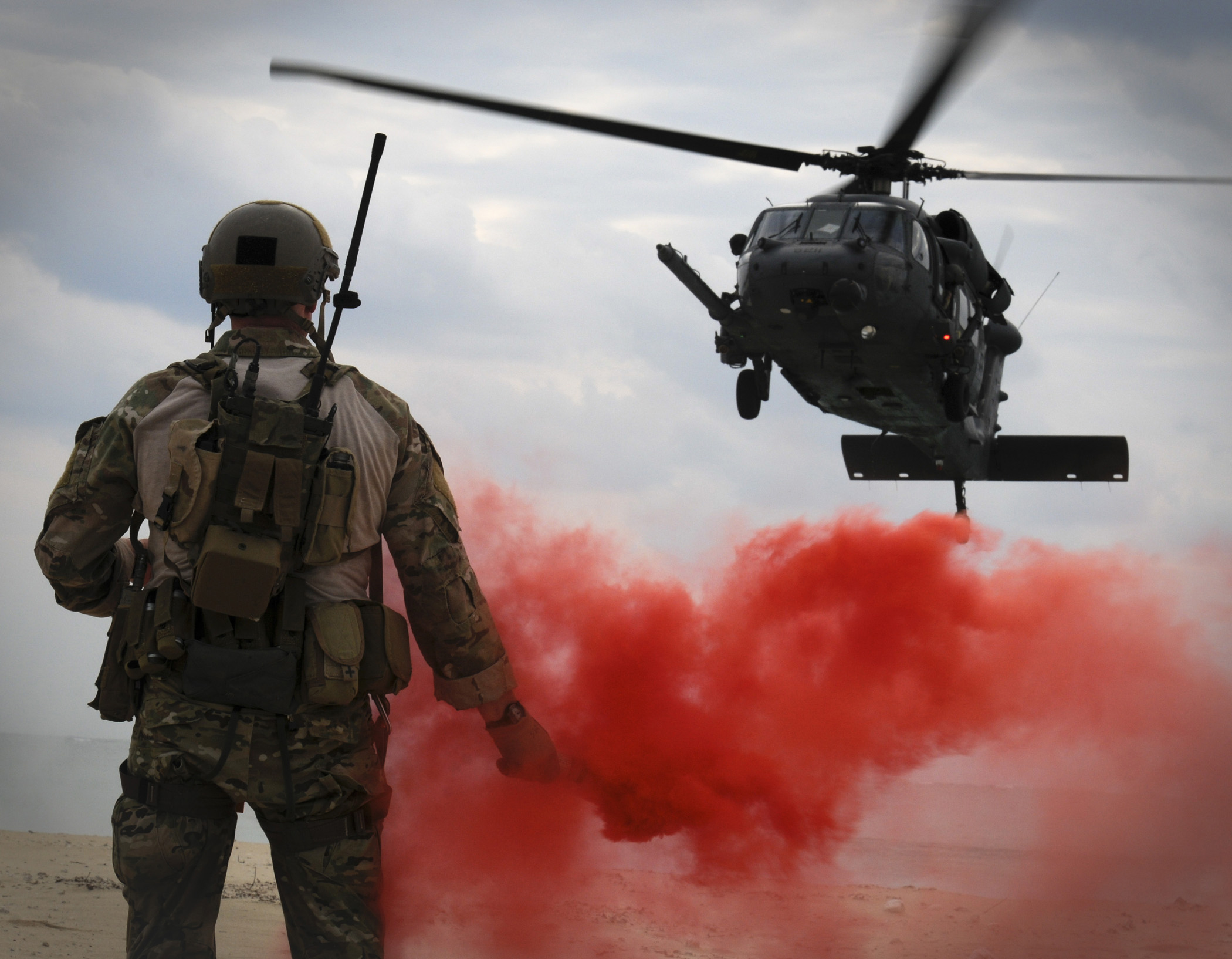 Maj. Matthew McGuinness pops a flare to signal an HH-60G Pave Hawk where to land by Maeson L. Elleman