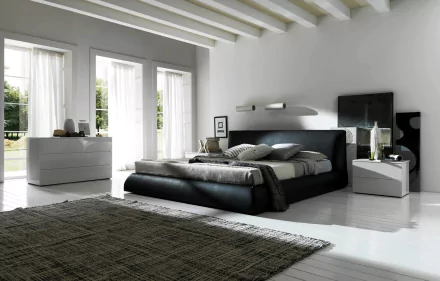 2K Quad HD PC desktop wallpaper: modern man-made bedroom interior with low black bed, cushions, nightstands, dresser, large windows and gray rug.
