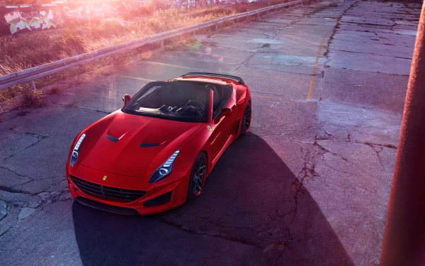 A red Ferrari California T parked on a sunlit, cracked asphalt road, captured in a vibrant 4K Ultra HD desktop wallpaper.