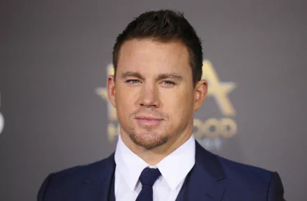 HD desktop wallpaper featuring American actor and celebrity Channing Tatum in a sharp suit against a blurred Hollywood backdrop.