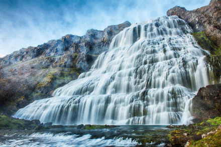 4K Ultra HD image of Dynjandi waterfall cascading over rocky cliffs in Iceland’s pristine natural landscape.