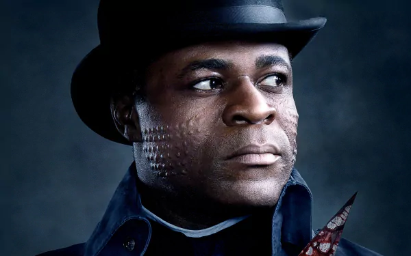 A striking HD wallpaper featuring Danny Sapani from the TV show Penny Dreadful, showcasing his intense expression and unique character details against a moody backdrop.