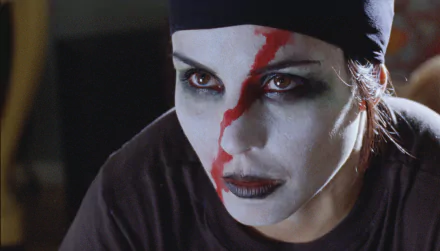 Close-up of Noomi Rapace with dramatic face paint from the movie The Girl Who Played With Fire, featured in an HD PC desktop wallpaper background.