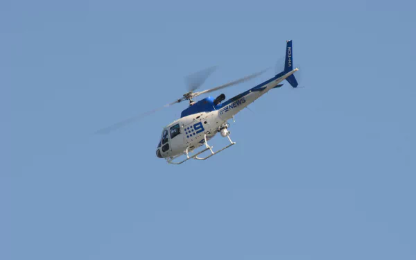 Eurocopter AS350 Écureuil helicopter, an air vehicle, in flight against a clear blue sky — HD PC desktop wallpaper background showing the light utility aircraft