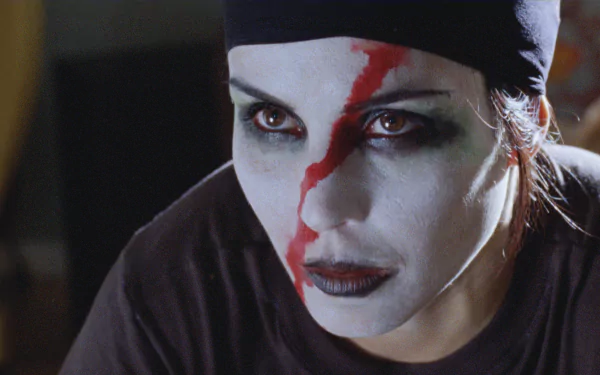 Close-up of Noomi Rapace with dramatic face paint from the movie The Girl Who Played With Fire, featured in an HD PC desktop wallpaper background.