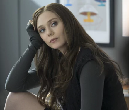 HD wallpaper featuring American actress Elizabeth Olsen as Scarlet Witch from the movie Captain America: Civil War, with long brunette hair, sitting thoughtfully with her head resting on her hand.