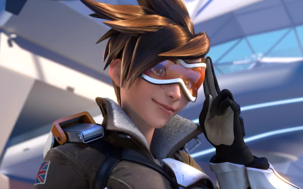 HD desktop wallpaper featuring Tracer from the video game Overwatch. Tracer is depicted with her signature goggles and confident smile, set against a futuristic background.