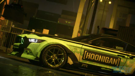 HD PC desktop wallpaper/background from the video game Need for Speed (2015): low-angle, neon-lit shot of a green Hoonigan drift car parked in a wet urban garage.