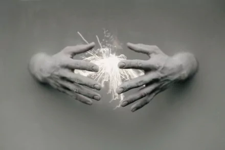 Artistic HD PC desktop wallpaper: two ethereal hands emerging from a gray background cradling a glowing, electric light orb.