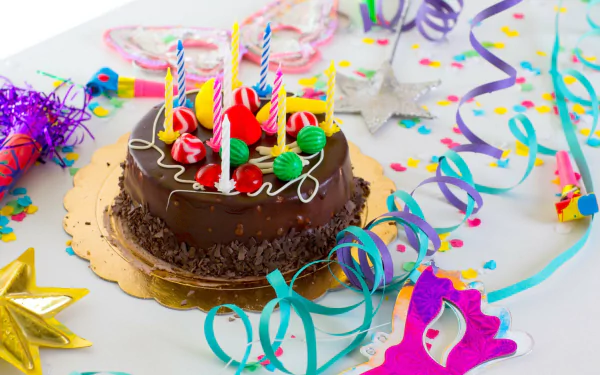 A festive chocolate cake adorned with colorful candles and candy sits surrounded by vibrant confetti and party decorations, capturing the joyful spirit of a birthday celebration.