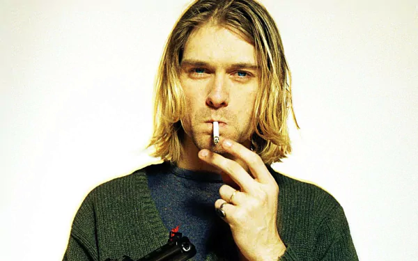 HD PC desktop wallpaper featuring a close-up image of Kurt Cobain smoking, capturing the iconic music figure with a plain light background.