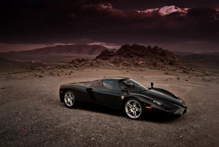 HD desktop wallpaper featuring a sleek black Ferrari Enzo supercar parked on rugged terrain under a dramatic sky, showcasing the iconic vehicle's design and power.