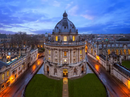 HD PC desktop wallpaper of man-made Oxford architecture at dusk: illuminated stone dome and surrounding college buildings.