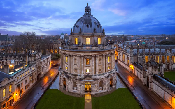 HD PC desktop wallpaper of man-made Oxford architecture at dusk: illuminated stone dome and surrounding college buildings.
