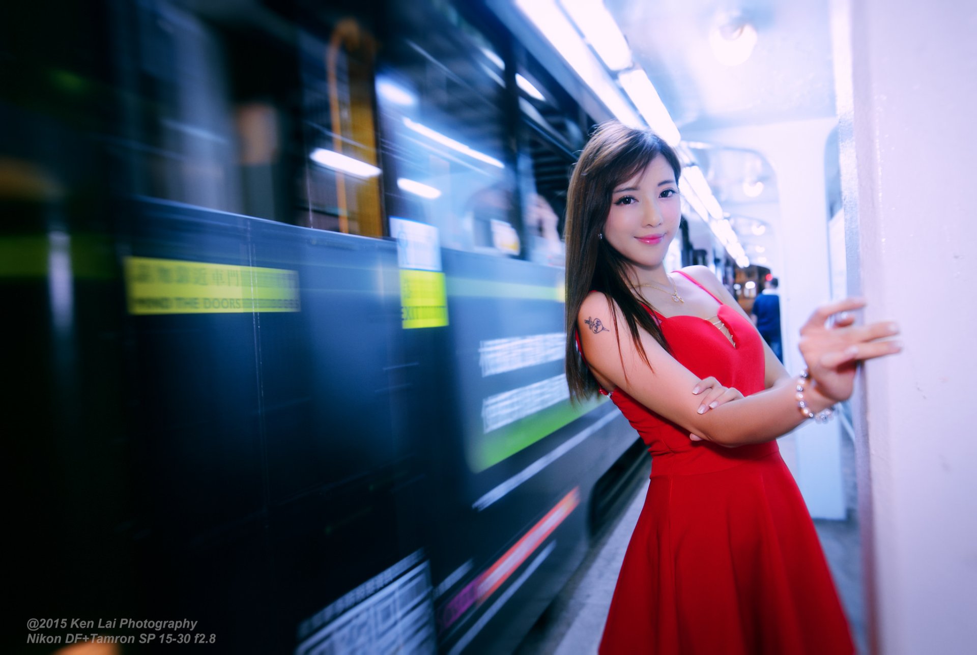 HD PC desktop wallpaper: woman (tagged Wing Wing) in a red dress posing on a subway platform, motion-blurred train in the background.