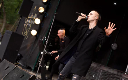 Two musicians on stage—lead vocalist with microphone and keyboardist—dark industrial/goth concert scene, 4K Ultra HD PC desktop wallpaper.