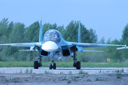A Sukhoi Su-34 jet fighter is positioned on a runway, showcasing its military design and features in a stunning 4K Ultra HD backdrop, surrounded by green landscapes.