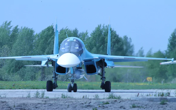 A Sukhoi Su-34 jet fighter is positioned on a runway, showcasing its military design and features in a stunning 4K Ultra HD backdrop, surrounded by green landscapes.