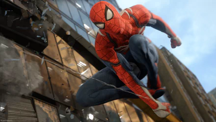 A high-definition desktop wallpaper featuring Spider-Man from the PS4 video game, dynamically leaping in front of a shattered building.