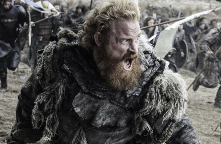 A high-definition wallpaper featuring Kristofer Hivju as Tormund Giantsbane from the TV show Game of Thrones, depicting him in mid-battle with a fierce expression.