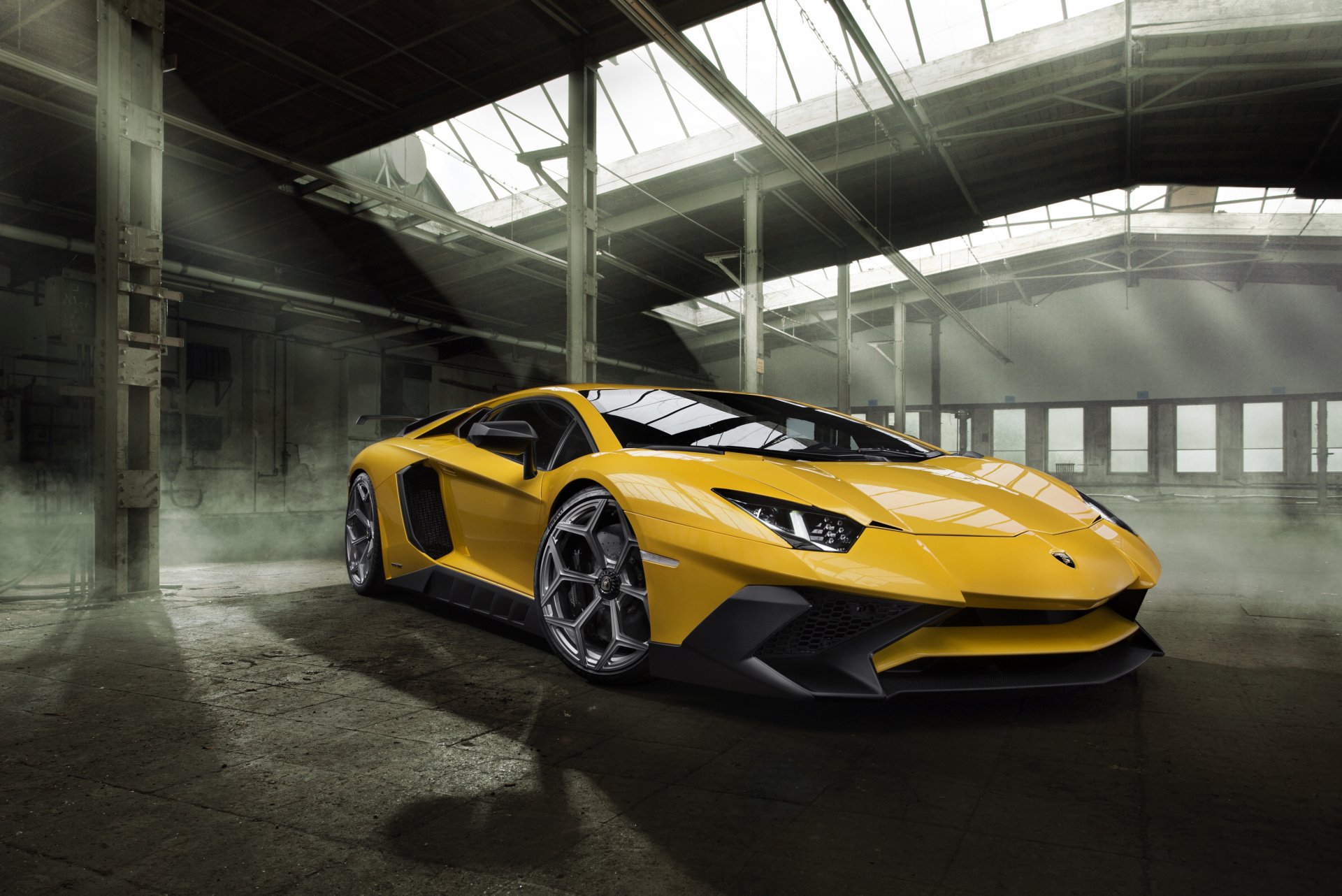 A striking yellow Lamborghini Aventador SV supercar displayed in a spacious industrial setting, captured in stunning 4K Ultra HD for a dynamic PC desktop wallpaper.