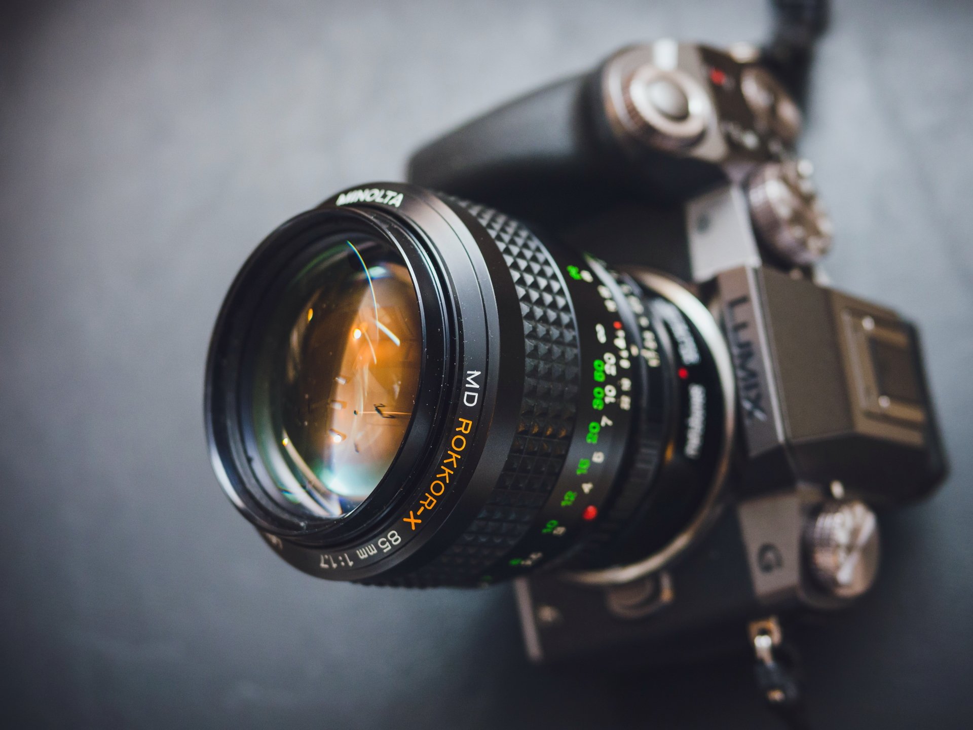 Close-up of a Lumix camera lens with detailed focus markings, captured in 4K Ultra HD as a sharp PC desktop wallpaper and background.