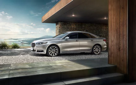 A silver Ford Taurus parked outside a modern house, captured in a high-resolution 4K Ultra HD desktop wallpaper showcasing the sleek vehicle and scenic background.