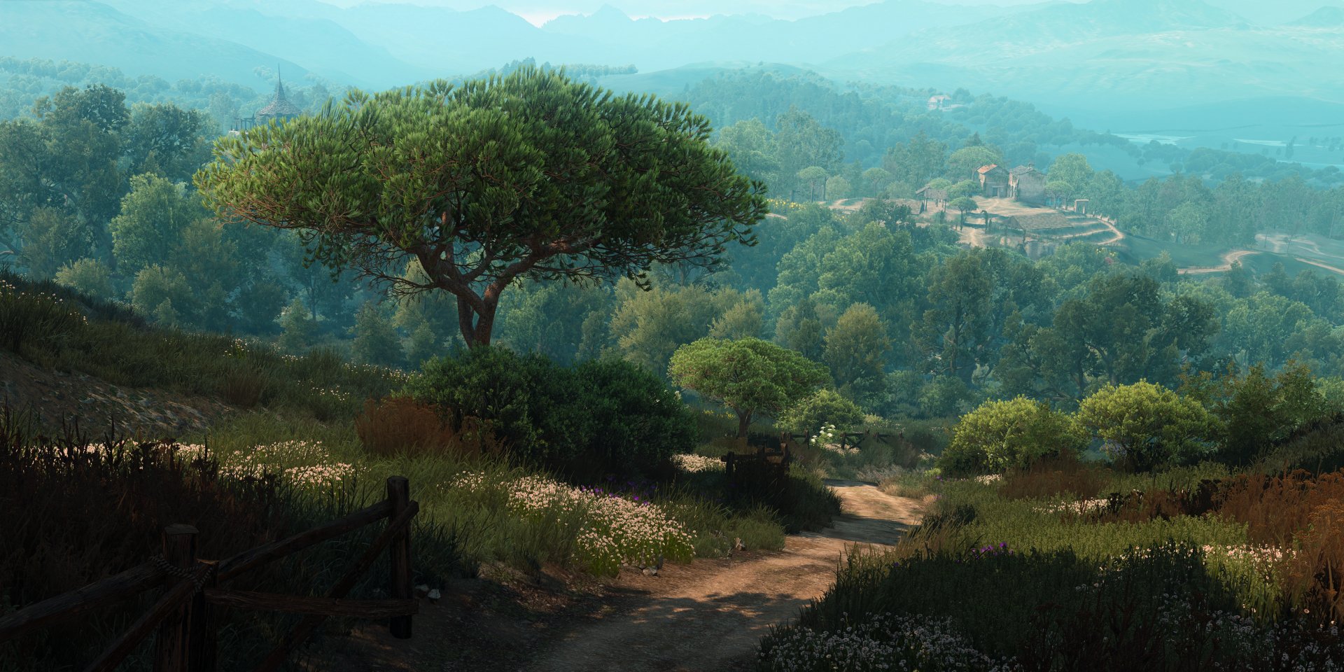A serene HD desktop wallpaper showcasing a lush, verdant landscape from The Witcher 3: Wild Hunt, featuring a tree-lined path, rolling hills, and distant structures under a clear blue sky.