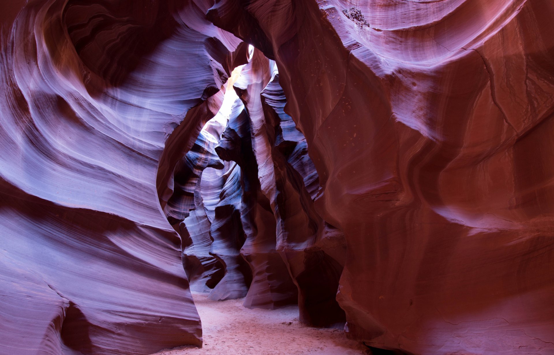 HD desktop wallpaper showcasing the stunning natural rock formations of Arizona's Antelope Canyon with light filtering through its smooth, curved canyon walls.