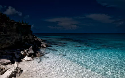 HDR landscape of a serene coastline with clear ocean waters and rocky shore, captured in high definition for a stunning PC desktop wallpaper.