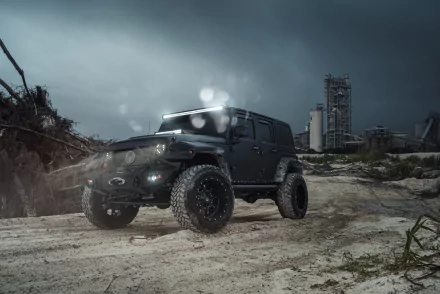 A striking black Jeep Wrangler SUV parked on a rugged terrain under a moody sky, showcasing its powerful design in this stunning 4K Ultra HD wallpaper.