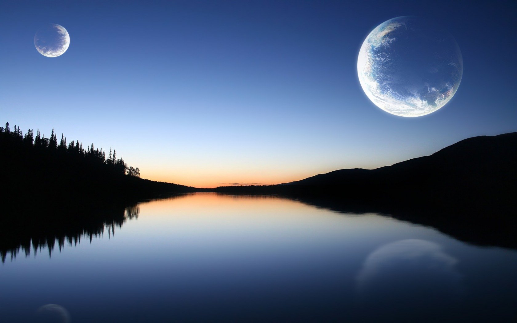 A serene sci-fi landscape featuring a calm lake reflecting a dusk sky, with two large planets hovering above a silhouette of distant trees. An HD desktop wallpaper that evokes tranquility and wonder.