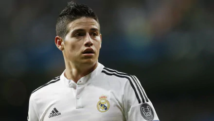 James Rodriguez in a Real Madrid C.F. jersey, showcasing his focus during a match. This high-definition image captures the essence of sports passion and dedication.