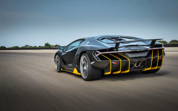 Black Lamborghini Centenario supercar speeding on open road, rear three-quarter view with yellow accents — 4K Ultra HD PC desktop wallpaper background.