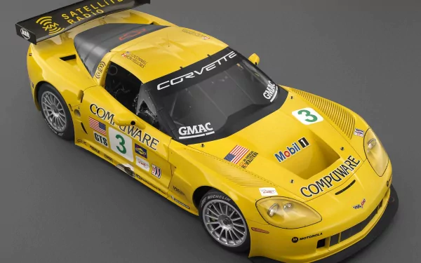 A striking yellow Chevrolet Corvette race car, showcasing its sleek design and racing decals, makes for an impressive HD desktop wallpaper and background.