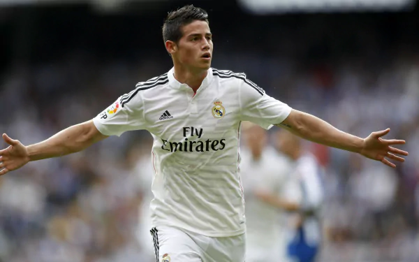 James Rodriguez celebrating a goal in a Real Madrid C.F. jersey, captured in a high-definition desktop wallpaper and background.