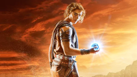 A character from Gods Of Egypt holds a glowing orb against a dramatic sunset backdrop, creating an epic atmosphere for this HD desktop wallpaper.